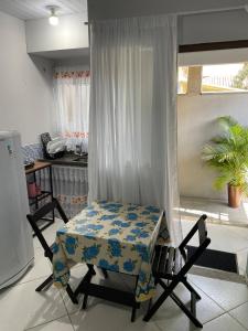a room with a table and chairs in a room at Kitnet aconchegante in Rio das Ostras +6 photos