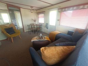 a living room with a couch and a table at Mount bolton mobile home in Portlaw