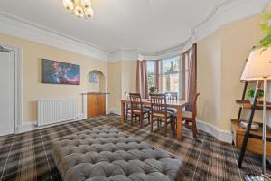una sala de estar con un sofá y una mesa en mySTAYINN Cedar Villa Guest House, en Inverness