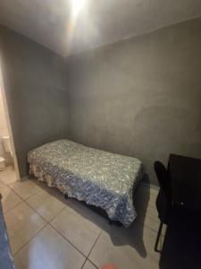 a small bedroom with a bed in the corner at aurora dois in Guarulhos