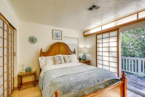 a bedroom with a bed and a large window at Relax on a Private Beach Shelton Getaway! in Shelton