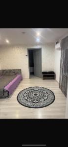 a bedroom with a bed and a rug on a wooden floor at Casa de vacanța in Brăila +1 photo