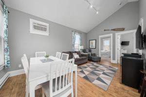 a kitchen and living room with a white table and chairs at The Rushes - 47 Butternut in Cherry Valley