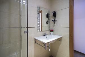 a bathroom with a sink and a shower at Hostal Drassanes in Barcelona
