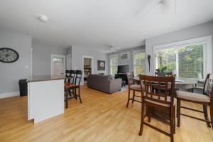 a kitchen and living room with a table and chairs at The Cattail - 26 Meadowview in Cherry Valley