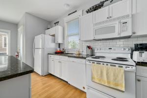 a kitchen with white appliances and white cabinets at The Cattail - 26 Meadowview in Cherry Valley +87 photos
