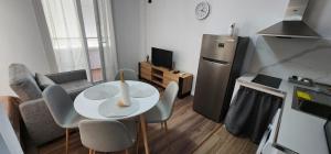 a small living room with a table and a refrigerator at Old Town City Center 2 in Durrës