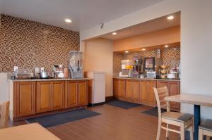 uma grande cozinha com armários de madeira e uma mesa em Vagabond Inn Bakersfield North em Bakersfield