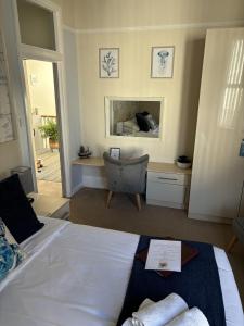 a bedroom with a bed and a desk and a chair at 74Belgravia in Torquay +10 photos