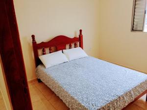 a bedroom with a bed with a blue comforter at Bem Estar5 in Aparecida +6 photos