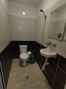a bathroom with a toilet and a sink at ELIT Holiday Village in Obzor