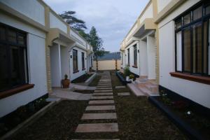 an empty courtyard of a building with a walkway at Adeea Suites Naivasha in Naivasha