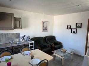 a living room with a couch and a table at Le repaire 3 in Saint-Omer-Capelle