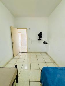 a room with a bed and a phone on the wall at Apartamento mobiliado em Contagem - 2 quartos in Contagem