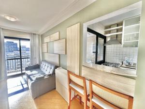 a living room with a couch and a table at Maison D Stan Moema with washing machine and daily cleaning in São Paulo