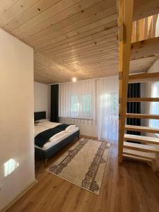 a bedroom with a bed and a wooden ceiling at Hotel Melishta in Peje