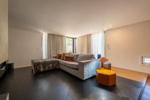 a living room with a couch and a table at HostWise - Modern Villa & Shared Pool in Paredes in Vandoma