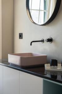 a bathroom with a sink and a mirror on a counter at HostWise - Modern Villa & Shared Pool in Paredes in Vandoma