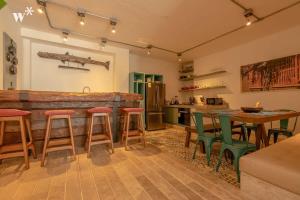 a kitchen and living room with a table and chairs at Castillo Grande Bayside Retreat 6BR 2 Homes in Cartagena de Indias