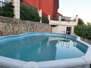 a swimming pool with blue water in front of a building at Casa rural "Garnacha de Borja" guest home in Borja