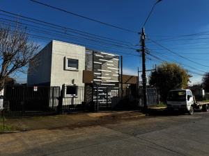a white truck parked in front of a house at Departamento Studio Full 109 in Osorno
