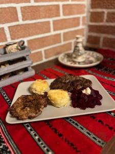 a plate of food on top of a table at Pensiunea Vila Maria in Crăcăoani