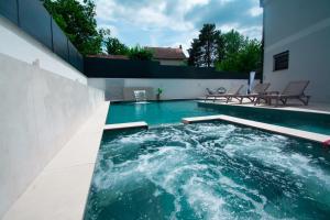 a swimming pool in the backyard of a house at Mi Casa in Vrdnik