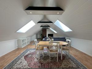 a dining room with a table and some skylights at Stintebakken 1 in Arendal