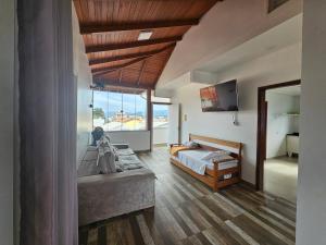 a bedroom with a bed and a large window at GH Barra da Lagoa in Florianópolis +201 photos