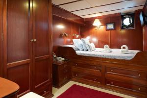 a boat cabin with a bed with swans on it at Southern Cross in Barcelona