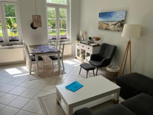 a living room with a couch and a table at Ferien auf traumhaftem Resthof in Twedt