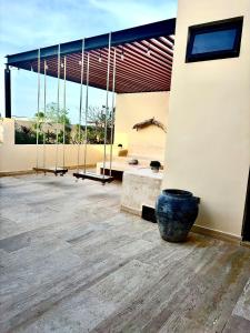 a building with a large pot in the middle of a room at Casa Vibe Tulum Penthouse, Private Pool & Terrace in Tulum