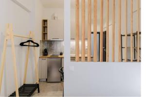 two images of a kitchen and a staircase in a house at Ladadika Vibes Studio 2 in Thessaloniki