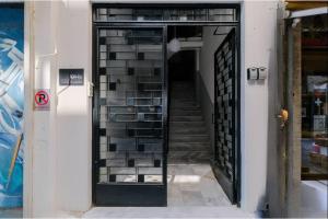 a stairway leading to a building with a glass door at Ladadika Vibes Studio 2 in Thessaloniki +5 photos