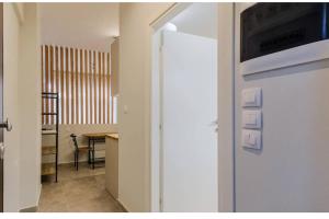 a door to a room with a table and a kitchen at Ladadika Vibes Studio 2 in Thessaloniki