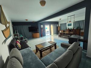 a living room with a couch and a table at lagoon apartment 3 in Moulay Bousselham