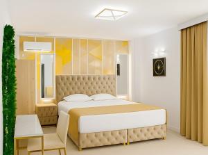 a bedroom with a large bed and a chair at Vila AMAZON in Dubova