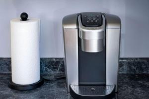 a paper towel roll next to a coffee maker at Coastal Haven in Dennis