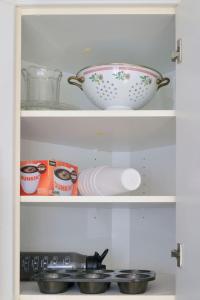 a cupboard with a bowl and dishes in it at Coastal Haven in Dennis