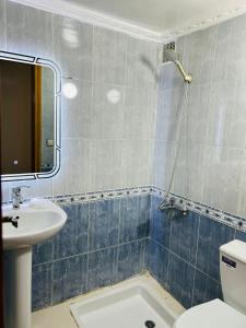 a bathroom with a sink and a toilet and a mirror at Fès Medina Escape Apartment in Fez