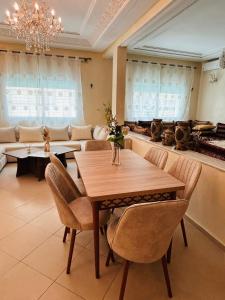 a dining room with a wooden table and chairs at Fès Medina Escape Apartment in Fez