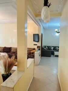 a living room with a couch and a tv at Fès Medina Escape Apartment in Fez