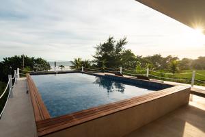 a swimming pool on the side of a house at Trika Surfcamp Bali in Airsatang