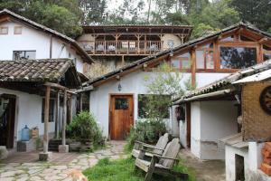 a house with a balcony on top of it at The Black Sheep Inn in Huamboya