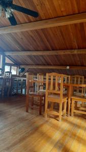 a dining room with wooden chairs and a wooden ceiling at The Black Sheep Inn in Huamboya +44 photos