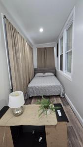 a bedroom with a bed and a table with a lamp at Serenity Haven in Irvington +10 photos