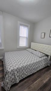 a bedroom with a bed with a patterned bedspread at Serenity Haven in Irvington