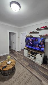 a living room with a large flat screen tv at Serenity Haven in Irvington