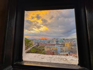 a view of a city from a window at Kalma Elephant Tower - Medieval Stay with a City View in Cagliari