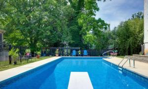 a swimming pool in a yard with a playground at Swimming Under The Stars In The Historical District in Lynchburg